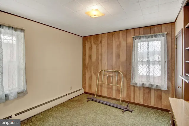 a view of an empty room with cabinet and entryway