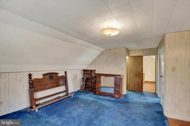 an empty room with windows and hardwood floor