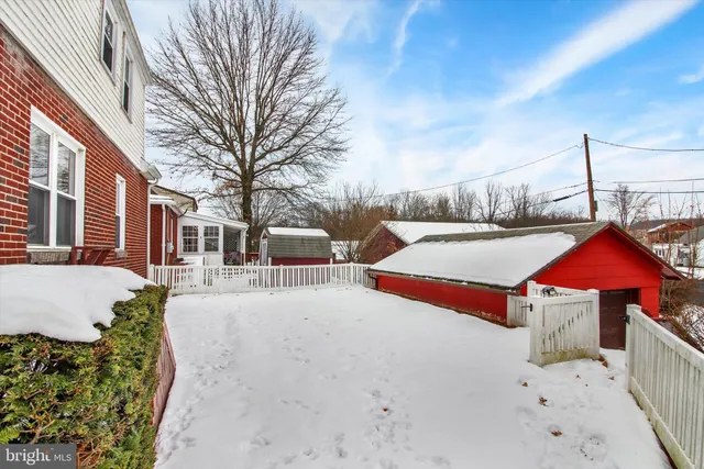 a view of a house with yard and covered with snow