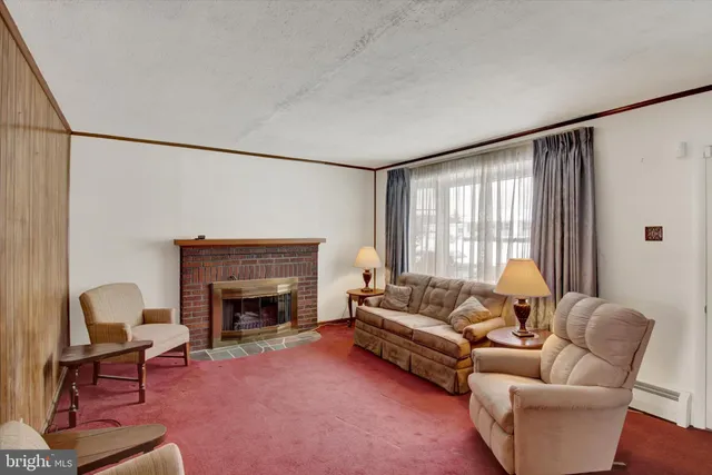 a large bedroom with a large bed a chandelier and glass door