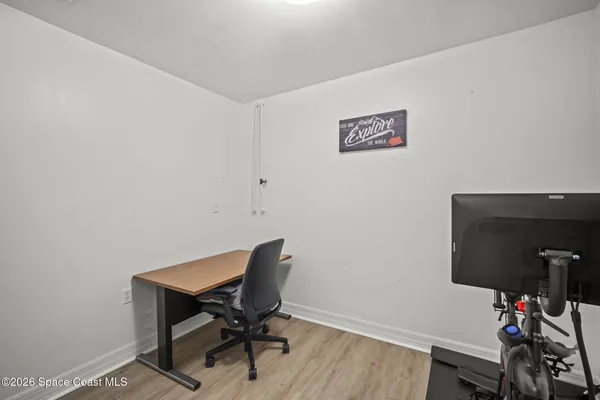a view of a workspace with furniture and wooden floor