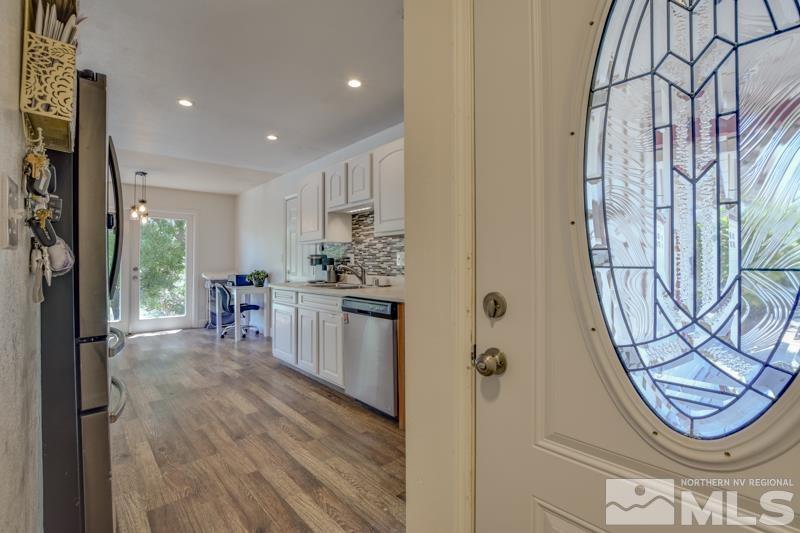 1450 Kirkham Way Reno, NV 89503 - Photo 5 of 20 a kitchen with stainless steel appliances granite countertop a refrigerator and a stove top oven