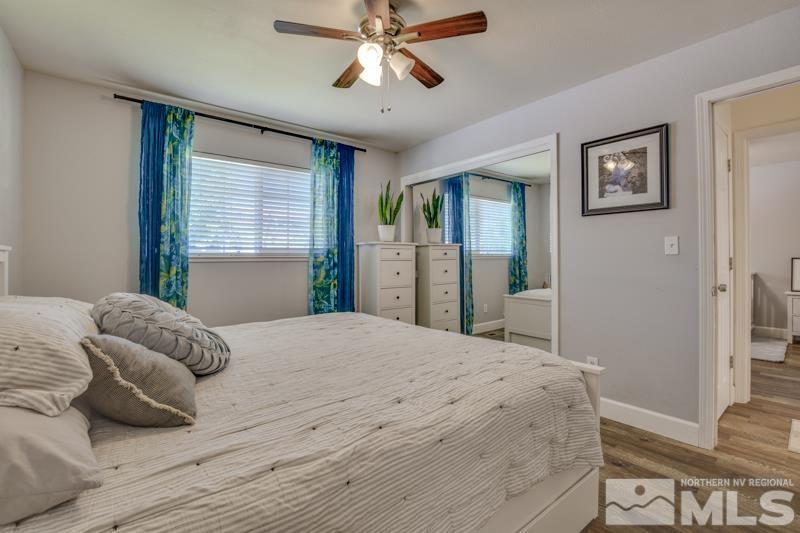 1450 Kirkham Way Reno, NV 89503 - Photo 9 of 20 a bedroom with a large bed and a chandelier