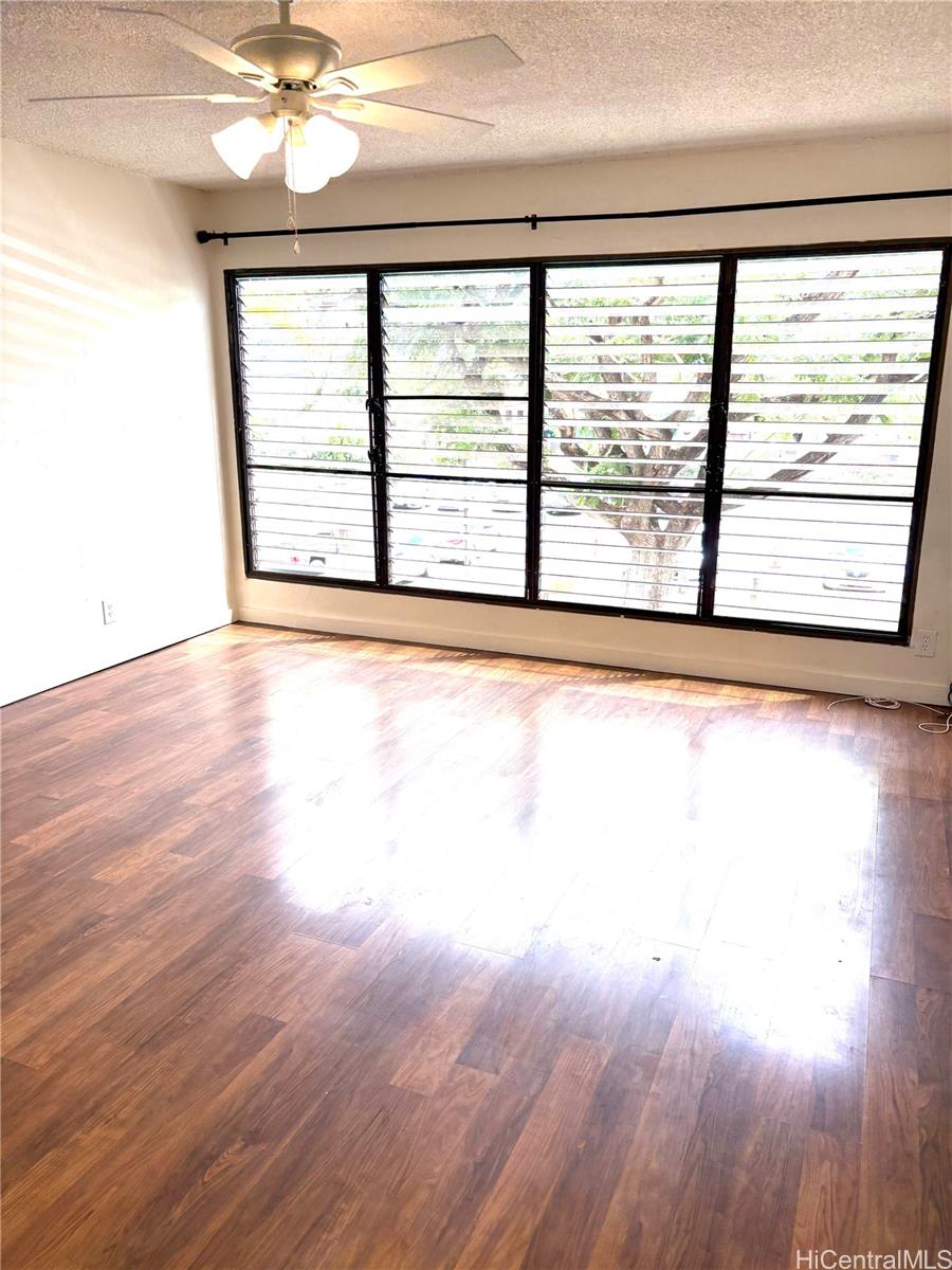 87-122 Helelua Street, Unit C204 Waianae, HI 96792 - Photo 1 of 14 a view of a room with wooden floor and a window
