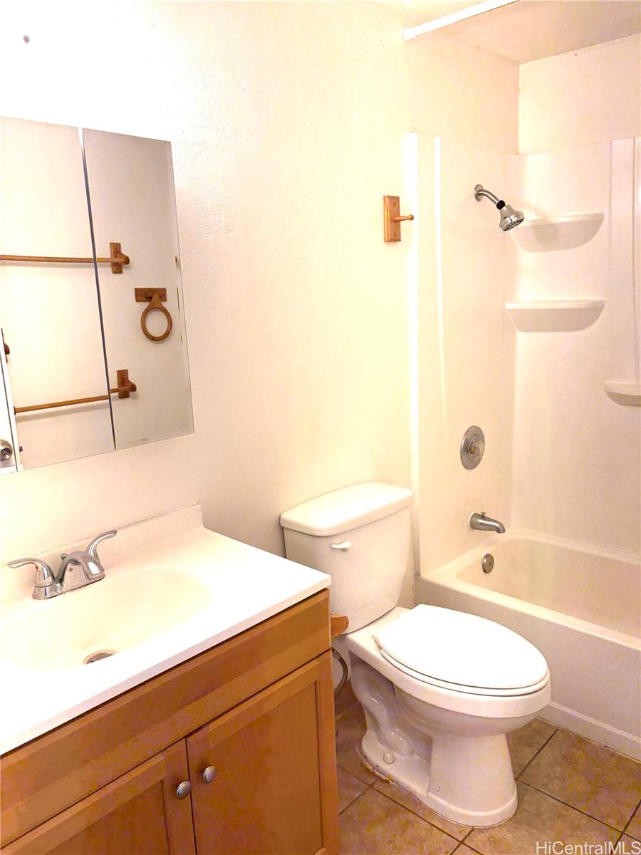 87-122 Helelua Street, Unit C204 Waianae, HI 96792 - Photo 2 of 14 a bathroom with a toilet a sink and bathtub