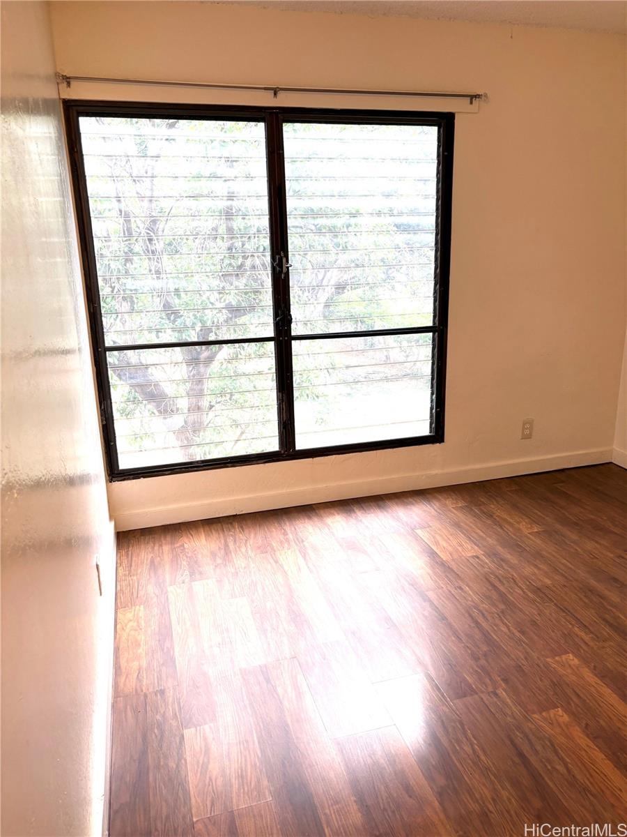 87-122 Helelua Street, Unit C204 Waianae, HI 96792 - Photo 5 of 14 a view of a room with wooden floor and a window