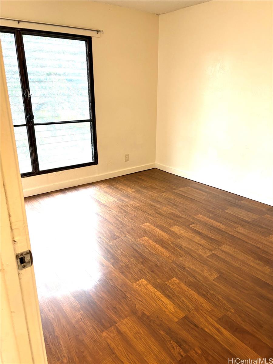 87-122 Helelua Street, Unit C204 Waianae, HI 96792 - Photo 7 of 14 a view of a room with wooden floor and small window