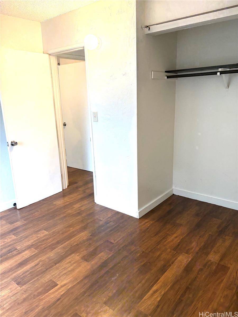87-122 Helelua Street, Unit C204 Waianae, HI 96792 - Photo 8 of 14 an empty room with wooden floor and a window