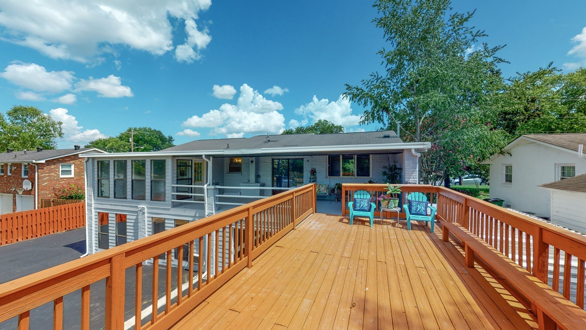 a view of house with deck and outdoor seating