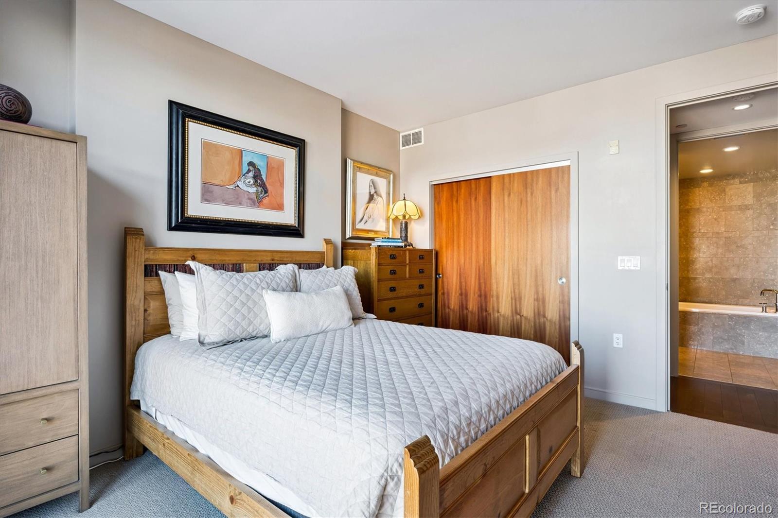 333 South Monroe Street, Unit 310 Denver, CO 80209 - Photo 16 of 33 a bedroom with a bed and a painting on the wall