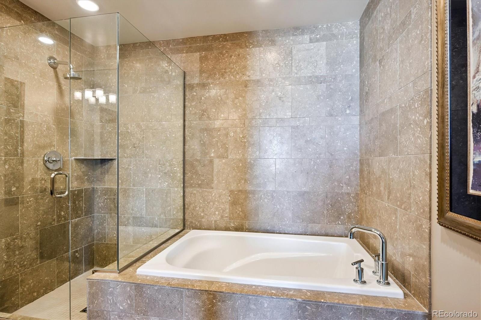 333 South Monroe Street, Unit 310 Denver, CO 80209 - Photo 19 of 33 a bath tub sitting next to a shower