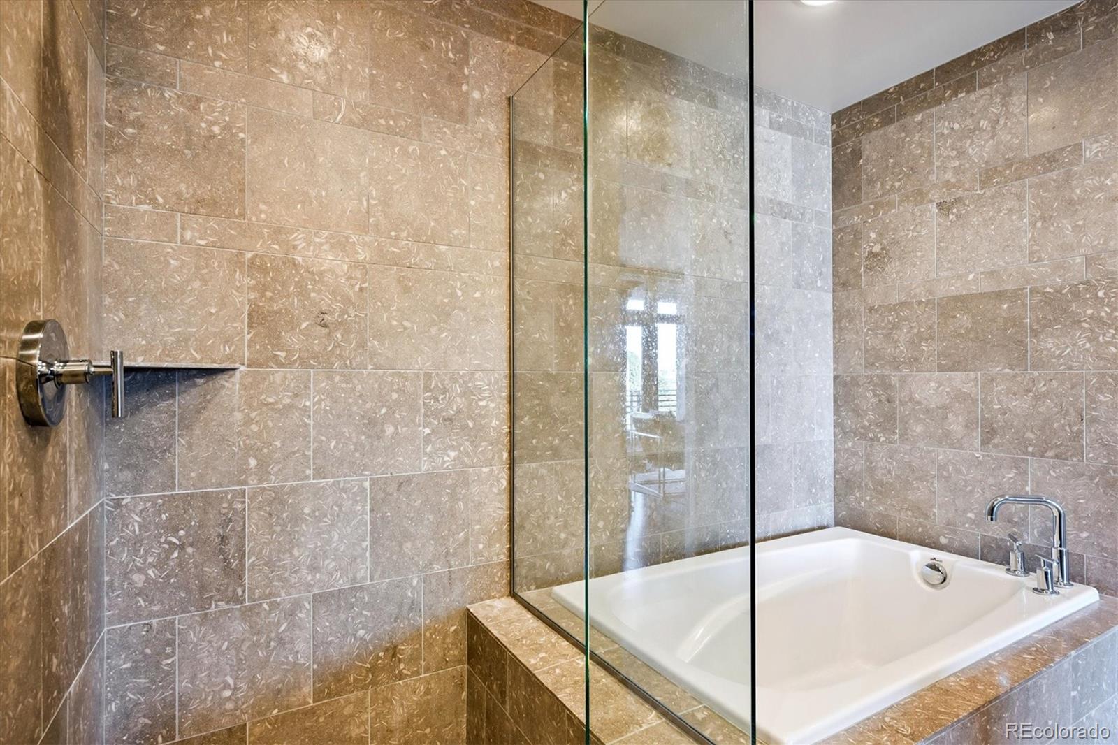 333 South Monroe Street, Unit 310 Denver, CO 80209 - Photo 20 of 33 a bathroom with a tub and shower