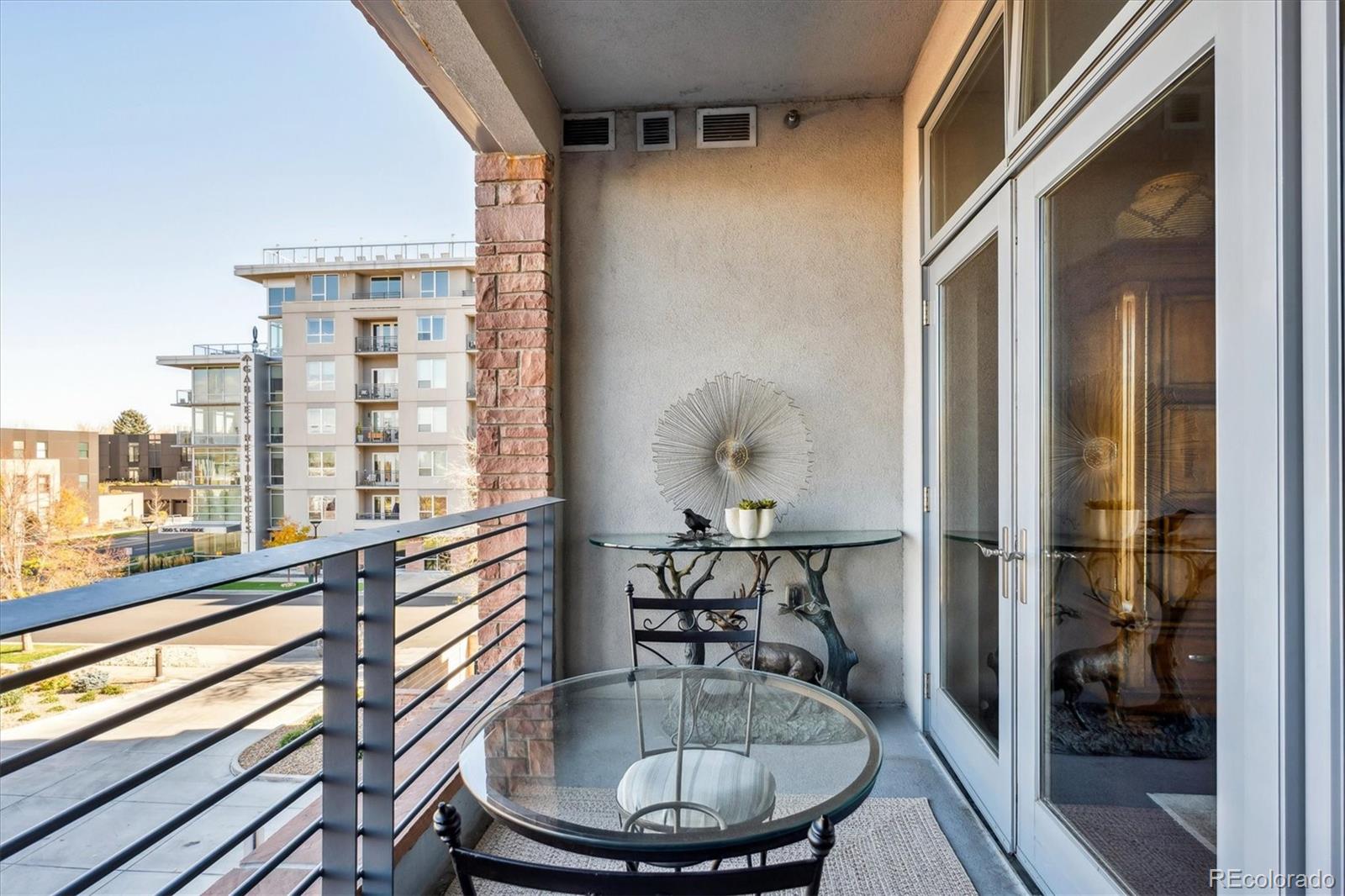 333 South Monroe Street, Unit 310 Denver, CO 80209 - Photo 22 of 33 a room with wooden floor table and chairs