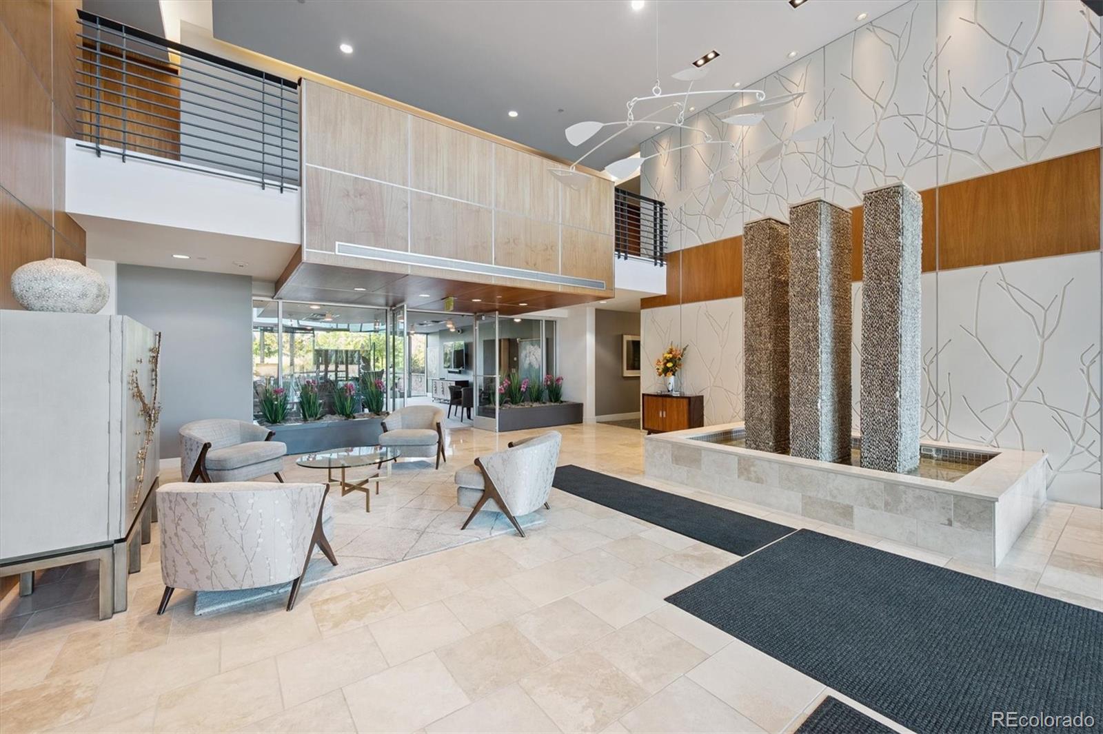 333 South Monroe Street, Unit 310 Denver, CO 80209 - Photo 24 of 33 a room with lots of white furniture and large windows