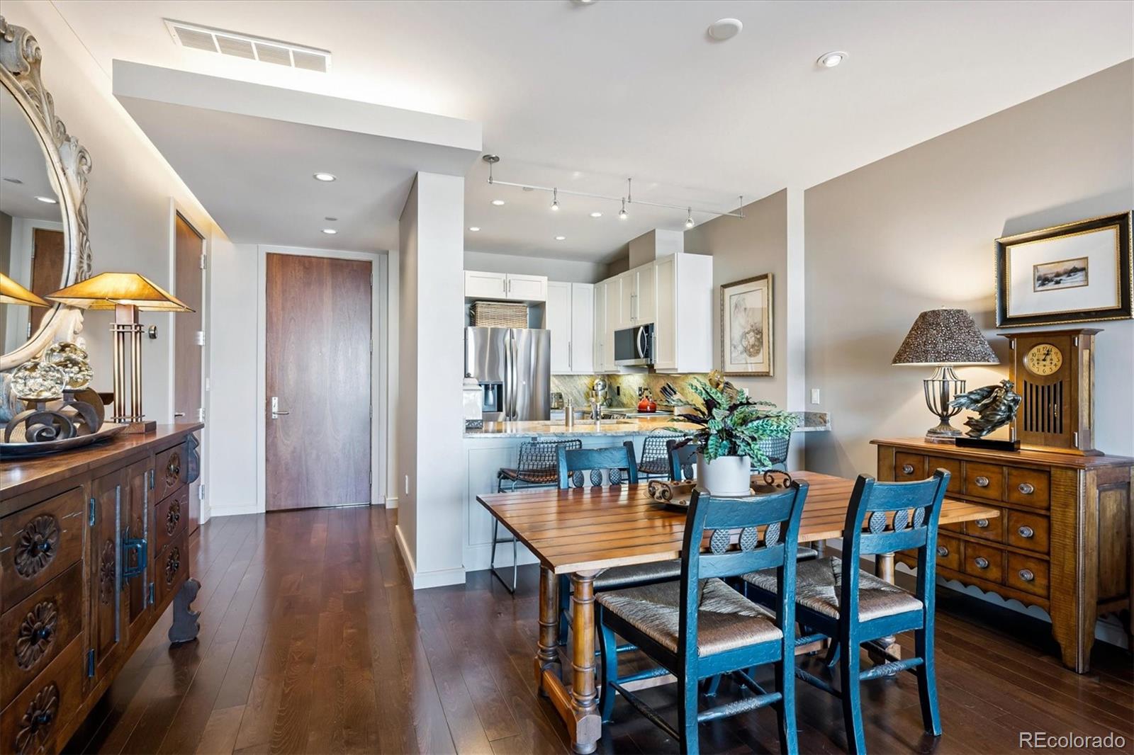 333 South Monroe Street, Unit 310 Denver, CO 80209 - Photo 5 of 33 a view of a dining room with furniture and wooden floor