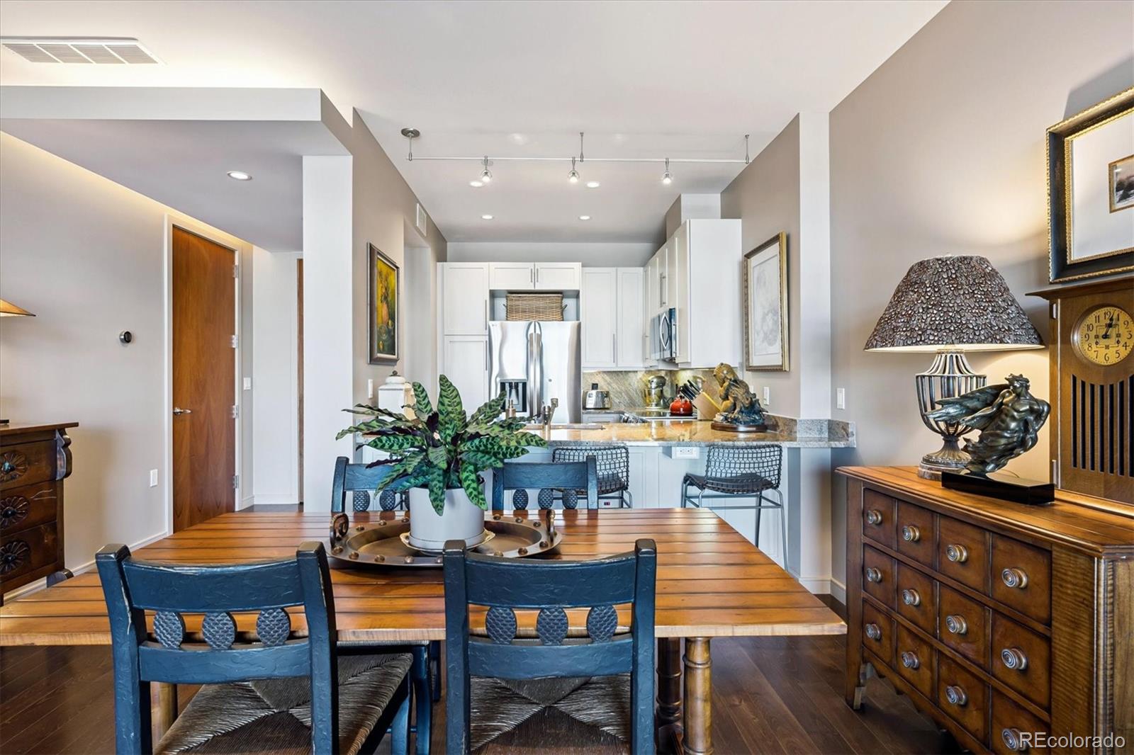 333 South Monroe Street, Unit 310 Denver, CO 80209 - Photo 10 of 33 a dining room with furniture and wooden floor