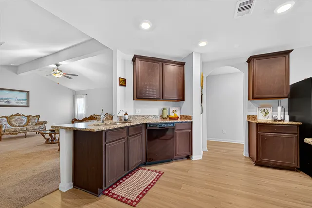 a view of kitchen with stainless steel appliances granite countertop a sink and stove