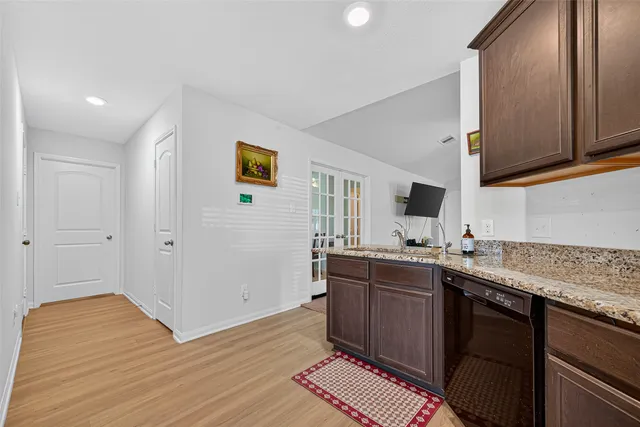 a kitchen with stainless steel appliances granite countertop a sink stove and cabinets
