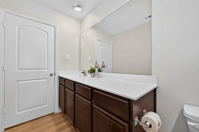 a bathroom with a sink vanity and a mirror