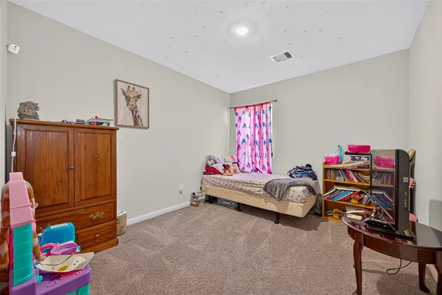 a bedroom with furniture and a window