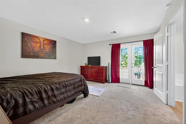 a bedroom with a large bed and a tv