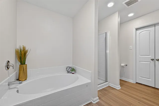 a bathroom with a bathtub and a shower