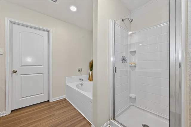 a bathroom with a bathtub and a shower