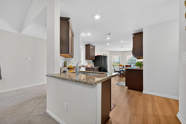 a kitchen with stainless steel appliances granite countertop a sink counter space and cabinets