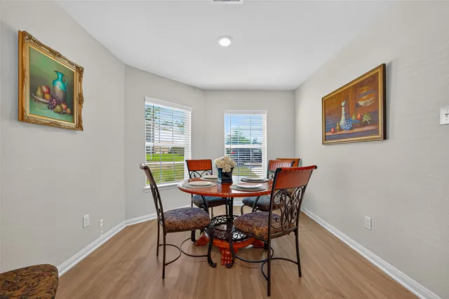 a view of a dining room with furniture and wooden floor
