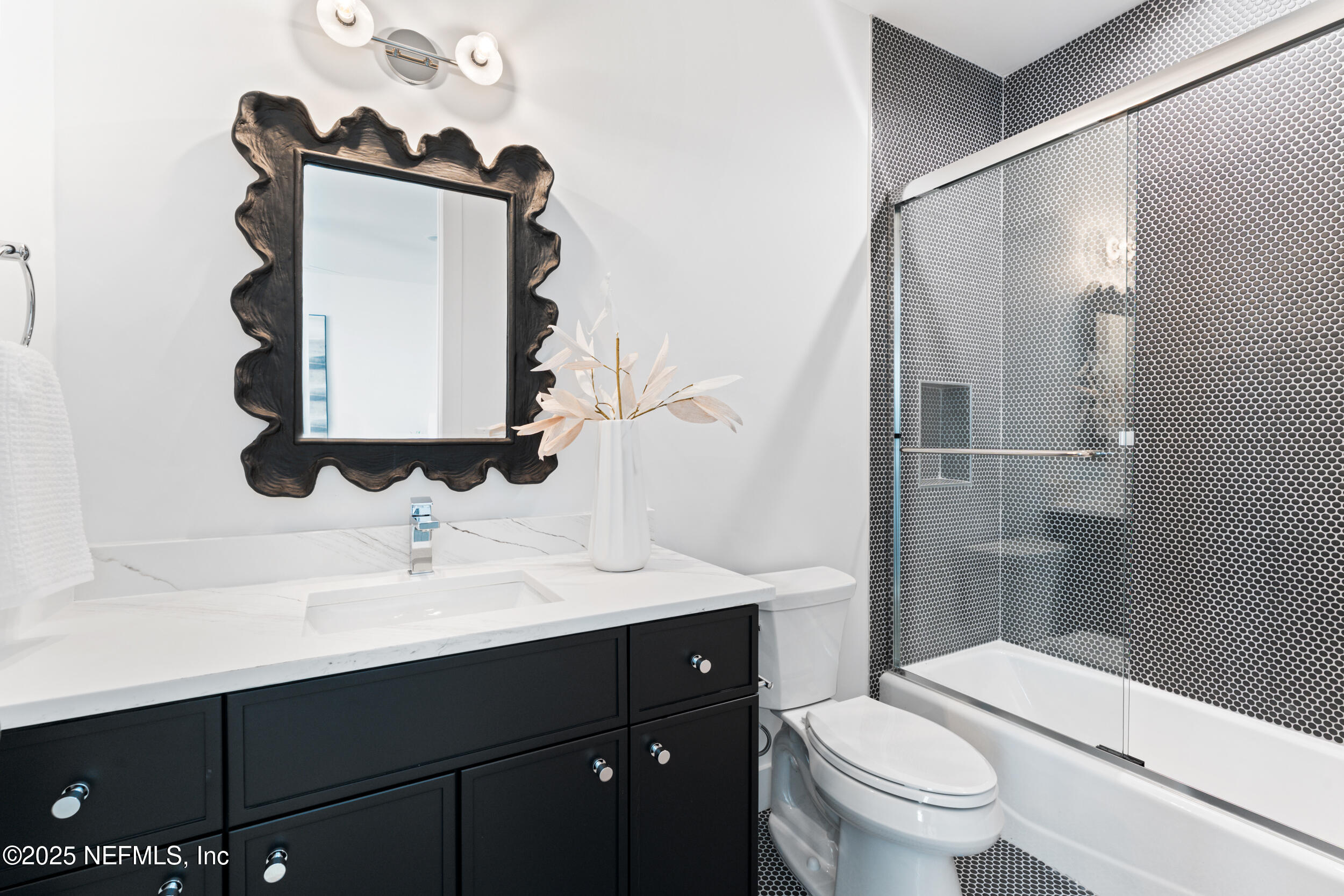 7 13th Street St. Augustine, FL 32080 - Photo 17 of 30 a bathroom with a sink vanity mirror and toilet