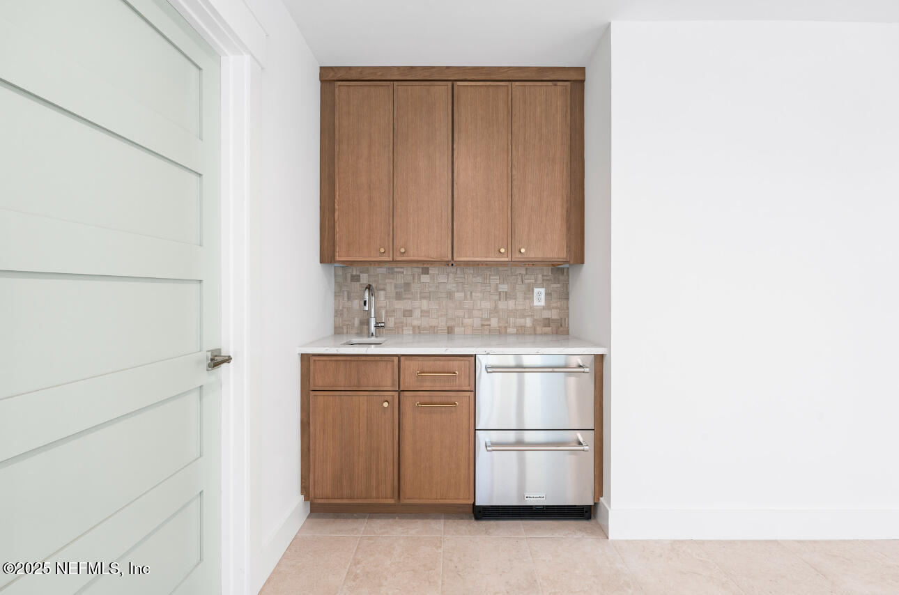 7 13th Street St. Augustine, FL 32080 - Photo 22 of 30 a kitchen with white cabinets and a stove