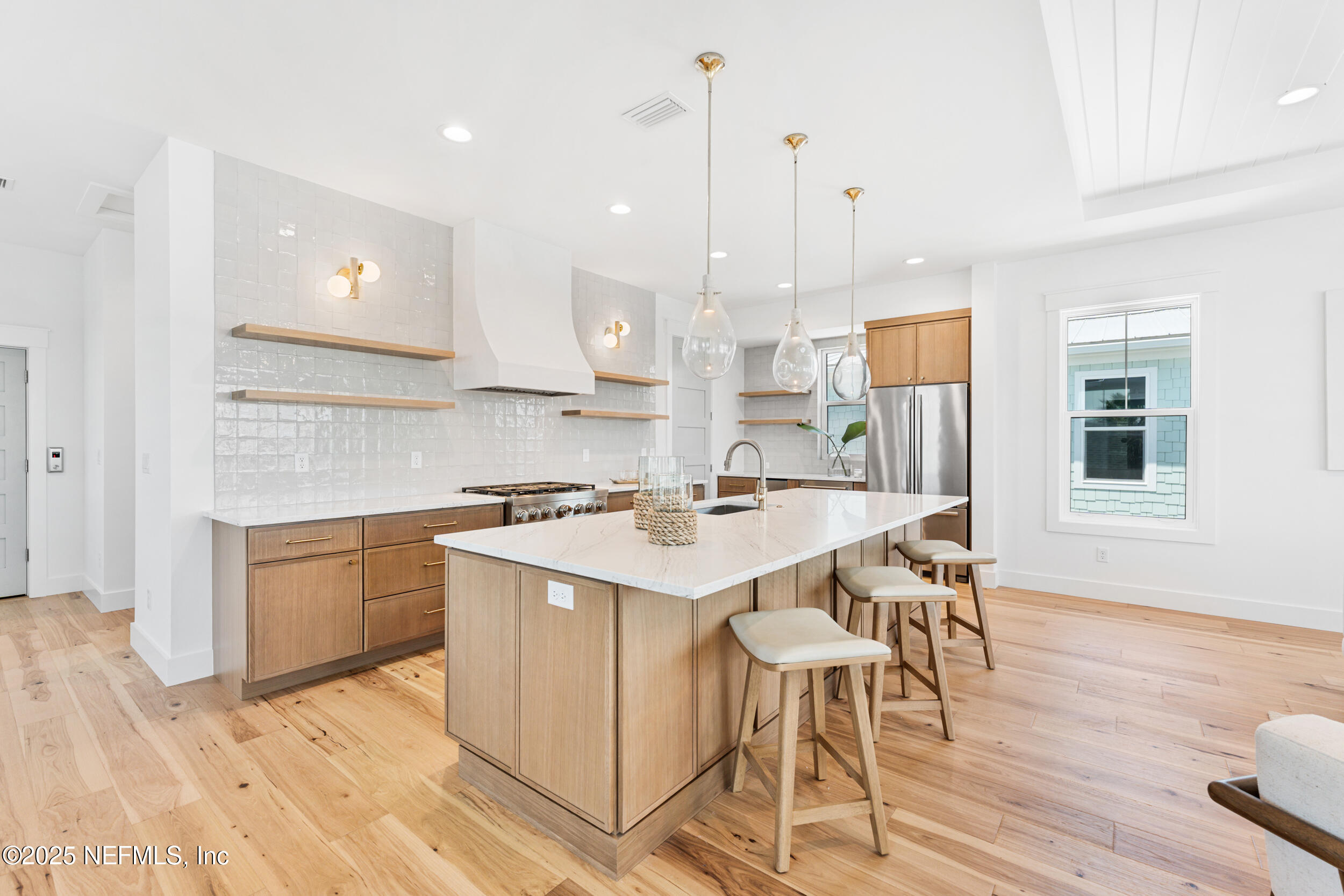 7 13th Street St. Augustine, FL 32080 - Photo 6 of 30 a kitchen with a table chairs sink and cabinets