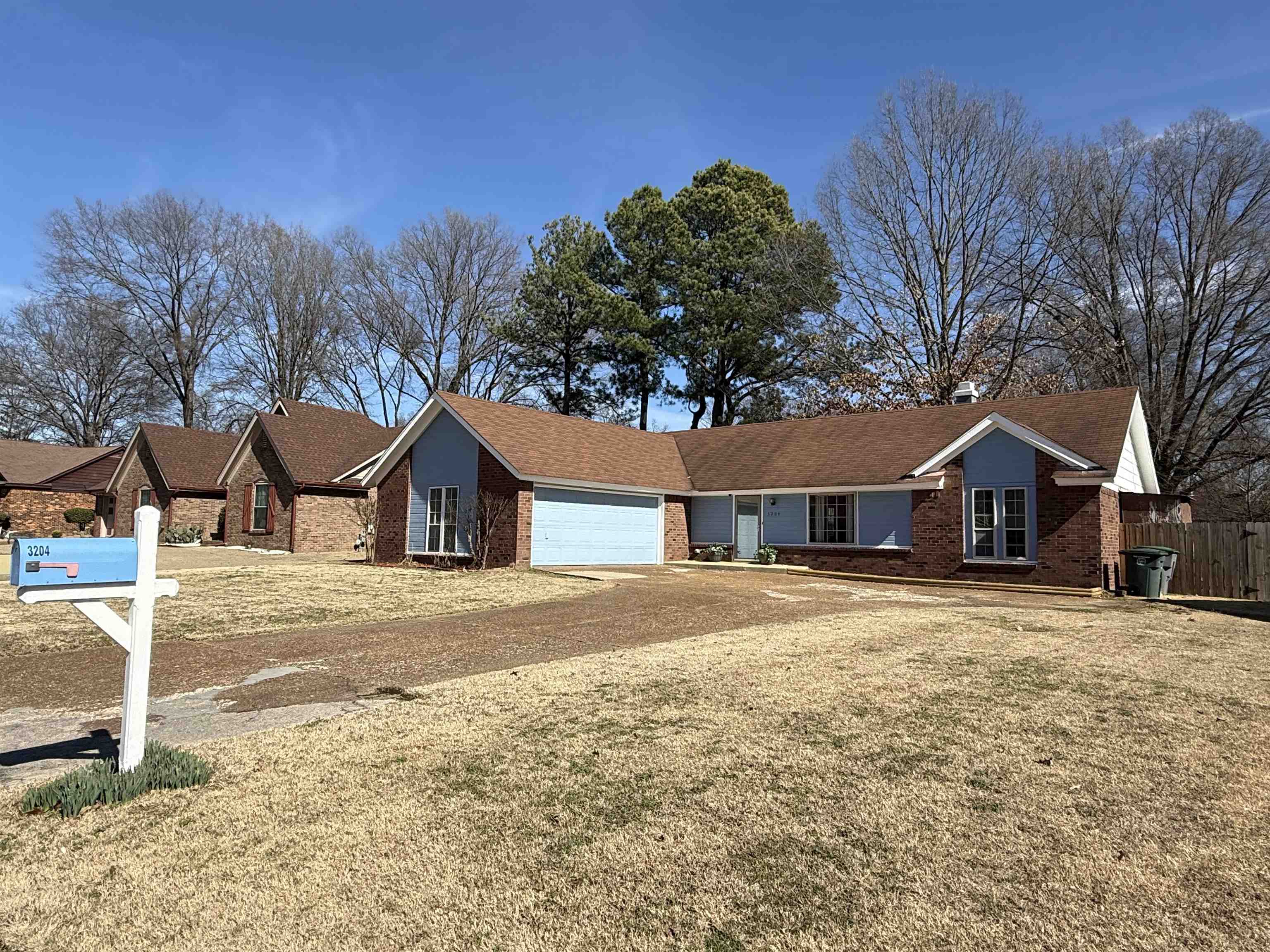 3204 Ruskin Road Memphis, TN 38134 - Photo 3 of 38 Ranch-style house featuring brick siding, an attached garage, and a front lawn