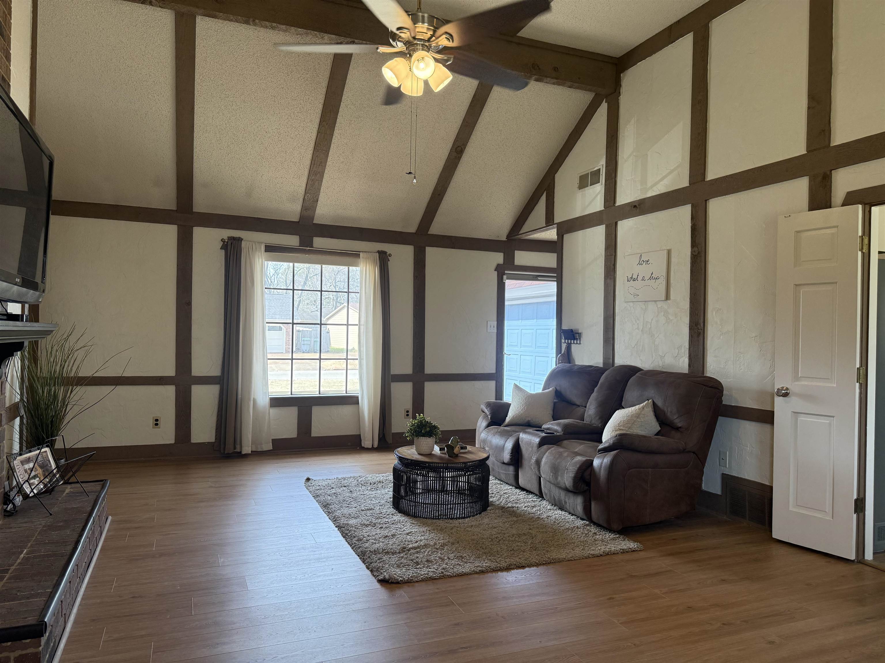 3204 Ruskin Road Memphis, TN 38134 - Photo 8 of 38 Living room featuring a fireplace, vaulted ceiling, a ceiling fan, and wood finished floors