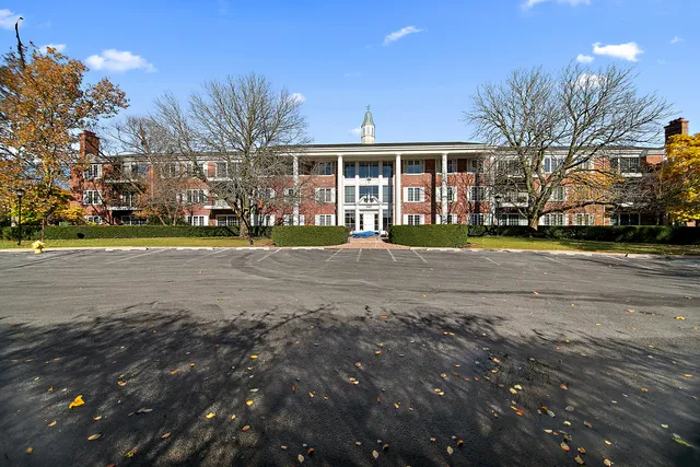 a front view of a building with trees