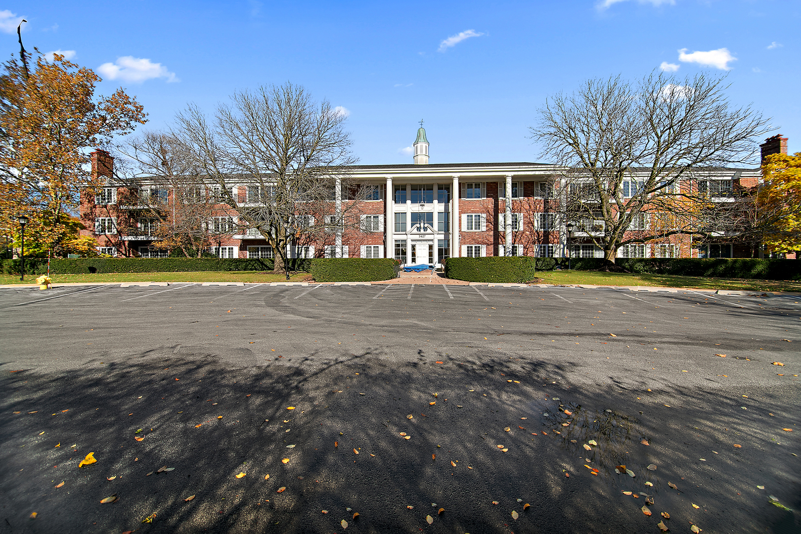 a front view of a building with trees