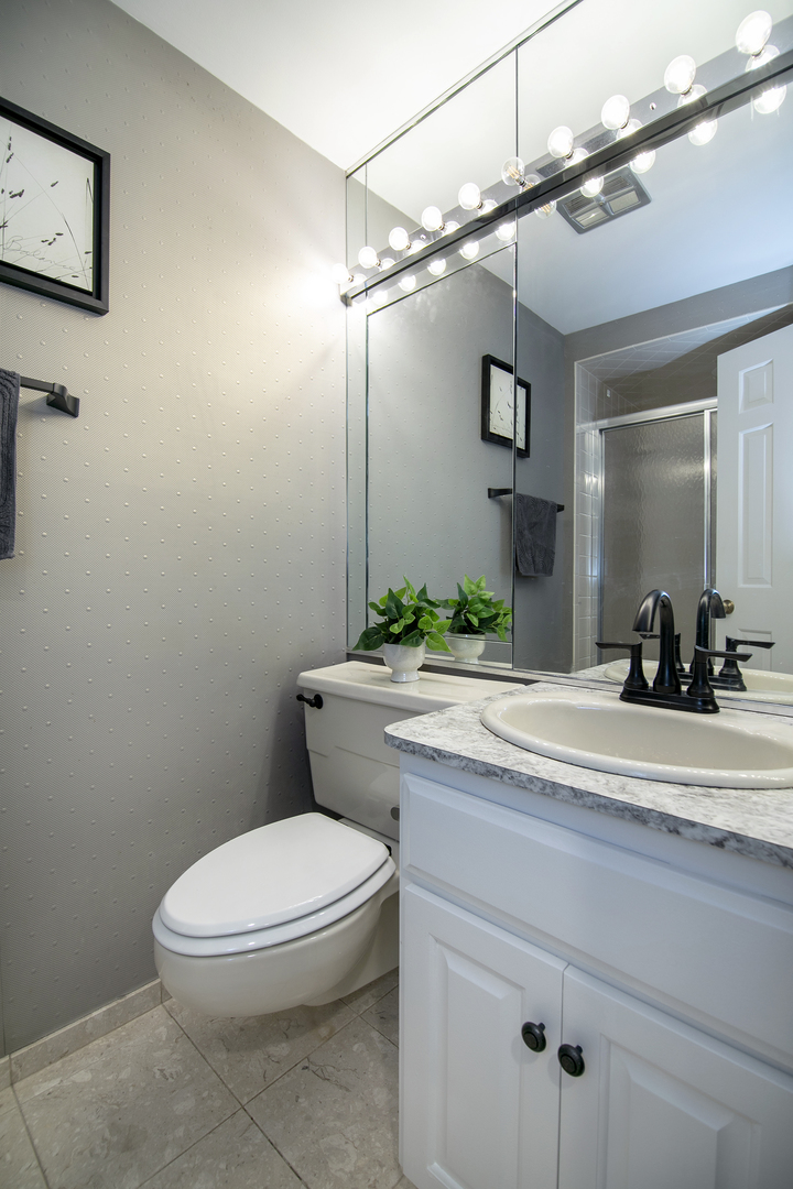 3427 Vollmer Road, Unit 202 Flossmoor, IL 60422 - Photo 18 of 27 a bathroom with a granite countertop toilet sink and mirror