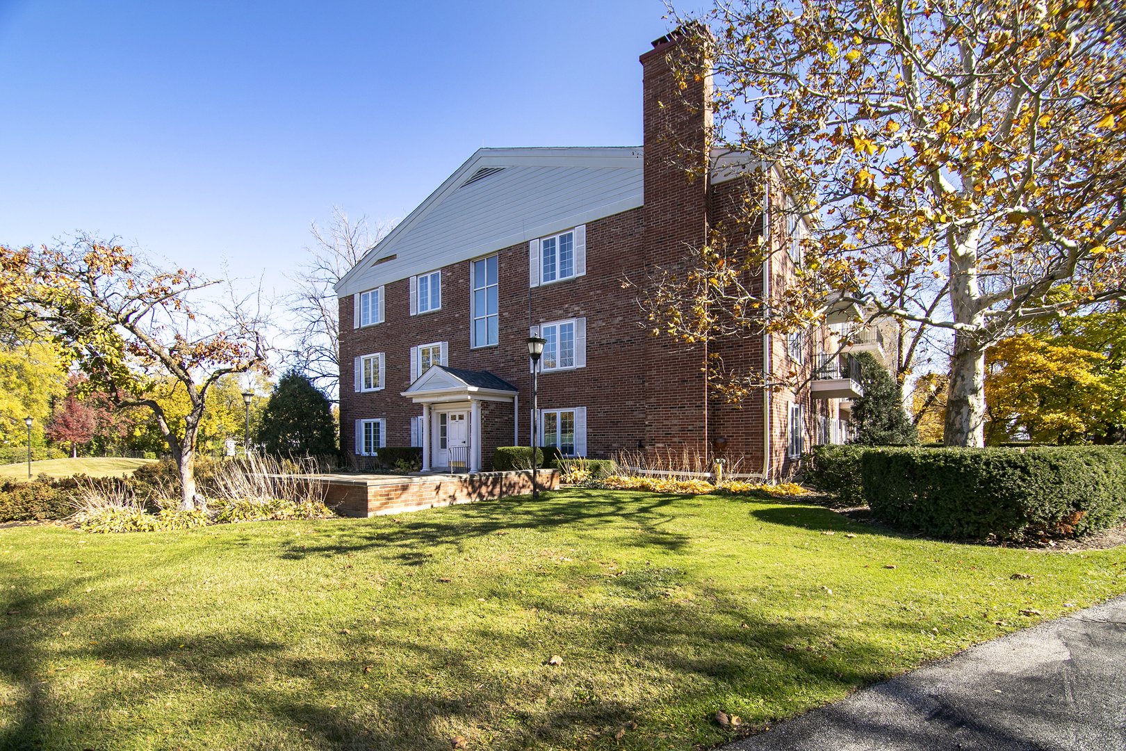 3427 Vollmer Road, Unit 202 Flossmoor, IL 60422 - Photo 2 of 27 a view of a swimming pool with a house in the background