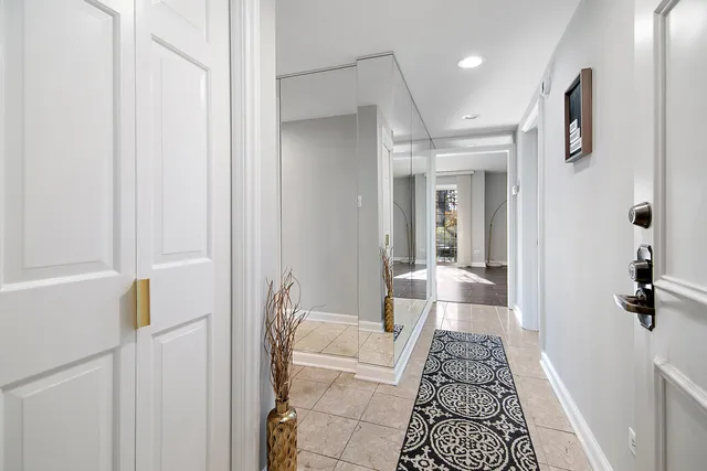 a bathroom with a sink and mirror with toilet
