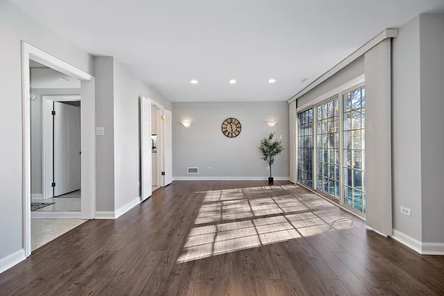 a view of empty room with wooden floor