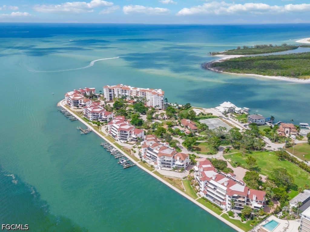 232 La Peninsula Boulevard, Unit 232 Naples, FL 34113 - Photo 36 of 44 a view of a lake with a big yard