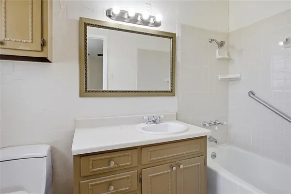 a bathroom with a sink a vanity and a bathtub