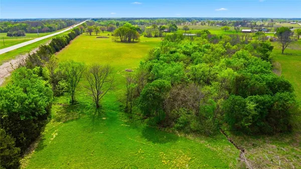 a view of a field with an trees
