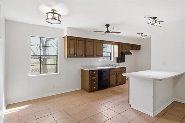 a kitchen with a stove window and cabinets
