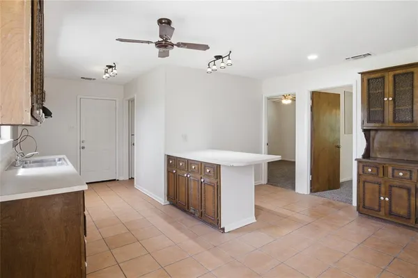 a view of a kitchen with refrigerator and cabinets
