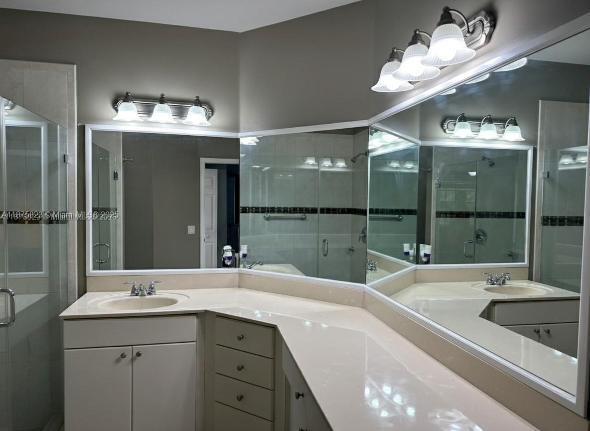 4959 Southwest 135th Way, Unit 4959 Miramar, FL 33027 - Photo 13 of 21 a bathroom with a sink double vanity and a large mirror