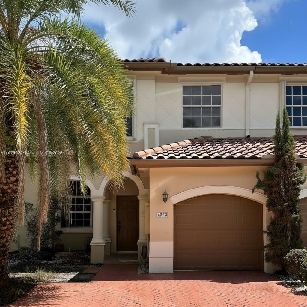 4959 Southwest 135th Way, Unit 4959 Miramar, FL 33027 - Photo 2 of 21 a front view of a house with a garden