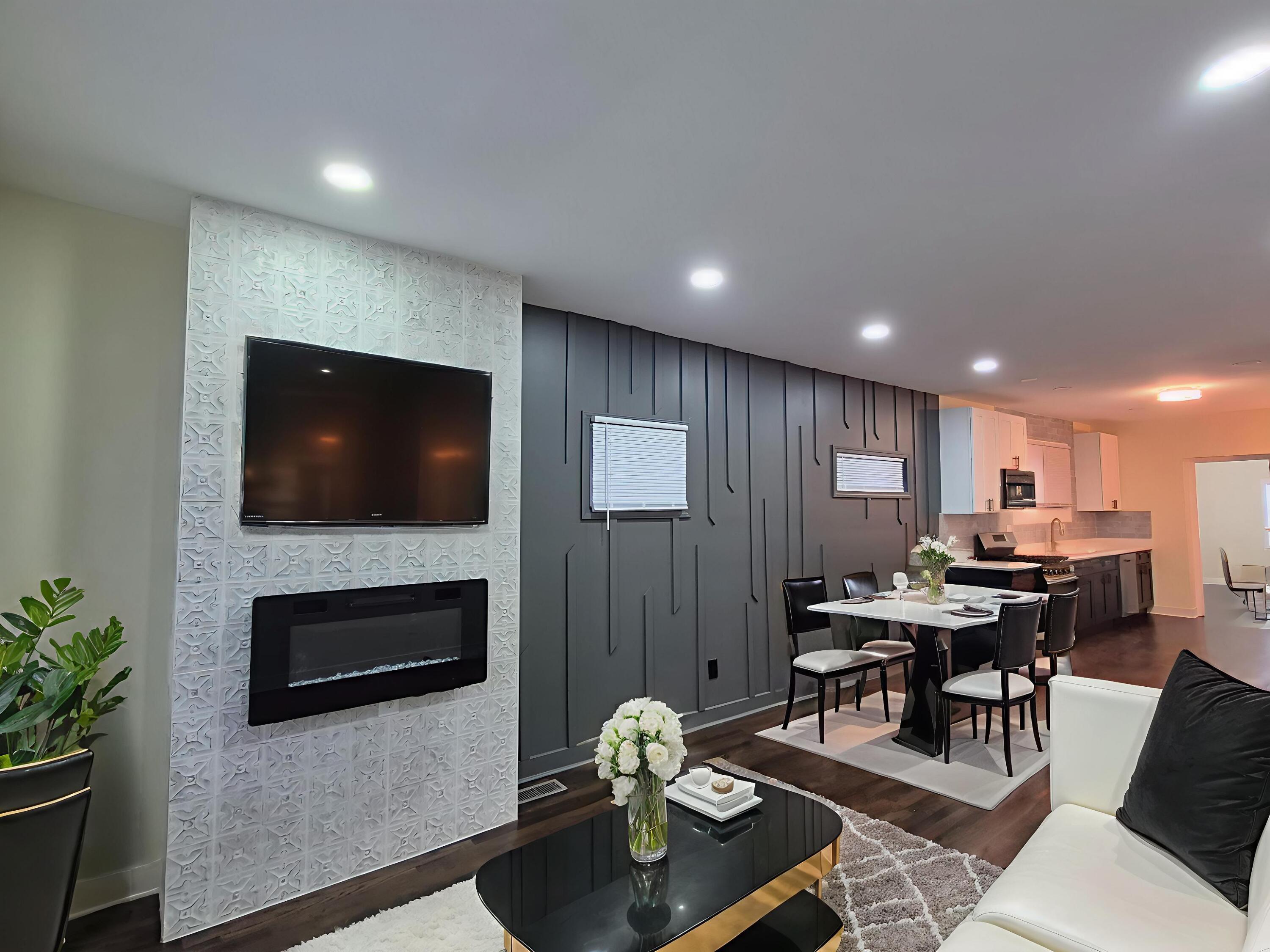 308 Pierce Street Gary, IN 46402 - Photo 3 of 23 a living room with furniture a flat screen tv and kitchen view