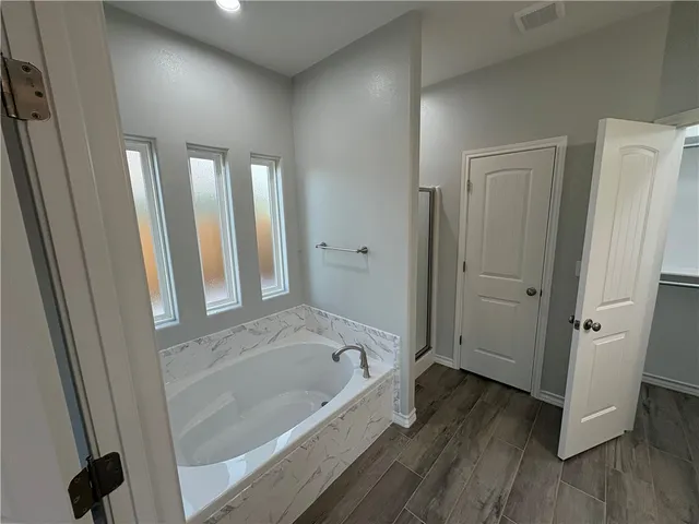 a bathroom with a bathtub and a shower