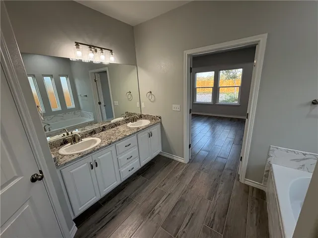 a bathroom with a double vanity sink and a mirror